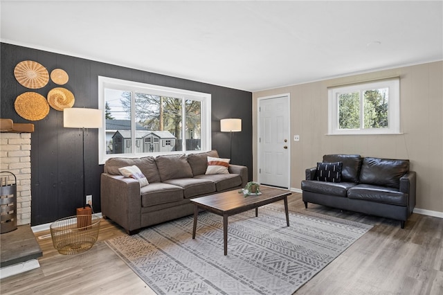 living area with baseboards and wood finished floors