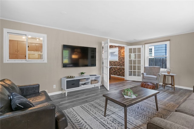 living room featuring french doors, baseboards, and wood finished floors