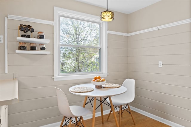 dining space featuring breakfast area and wood finished floors