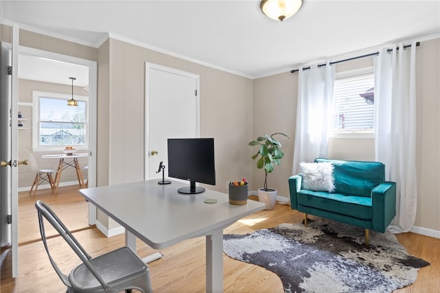 office space with crown molding and light wood-style floors