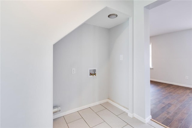 laundry room with laundry area, hookup for a washing machine, baseboards, and light wood finished floors
