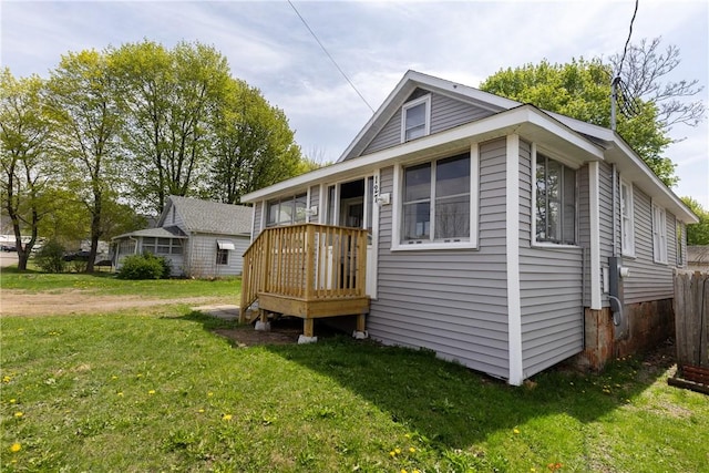 back of house with a lawn and a wooden deck