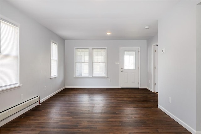 foyer entrance featuring baseboards, a baseboard heating unit, and dark wood-style floors