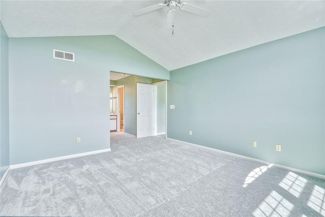 carpeted empty room with baseboards, ceiling fan, high vaulted ceiling, and visible vents