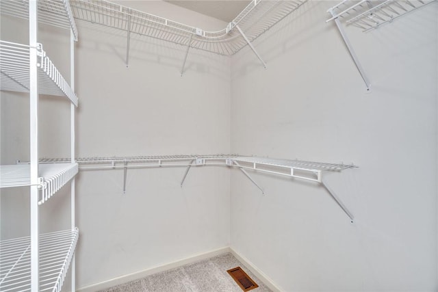 walk in closet featuring carpet floors and visible vents