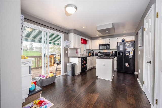 kitchen with white cabinets, dark countertops, a sink, dark wood-style floors, and black appliances