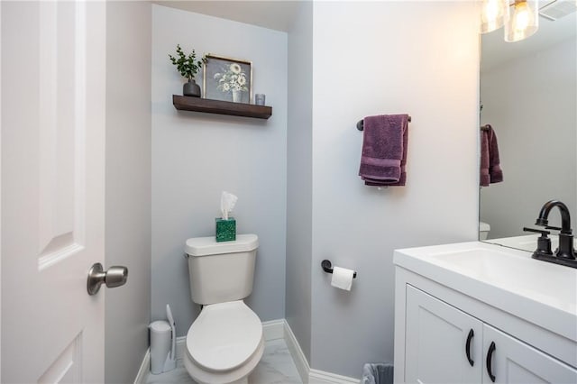 half bathroom with toilet, visible vents, marble finish floor, and vanity