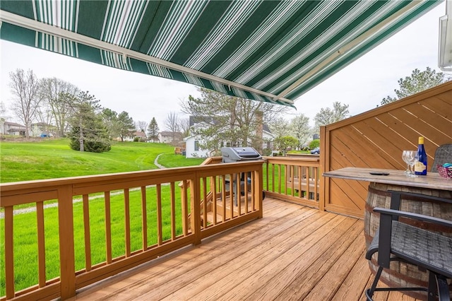 wooden terrace with a lawn