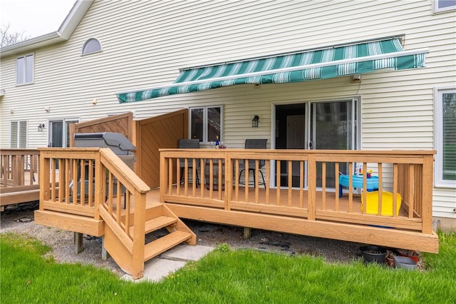 rear view of property with a wooden deck