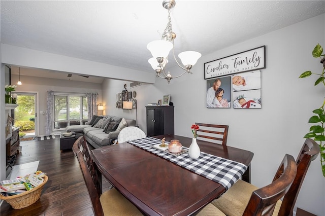 dining space featuring an inviting chandelier, hardwood / wood-style flooring, and visible vents