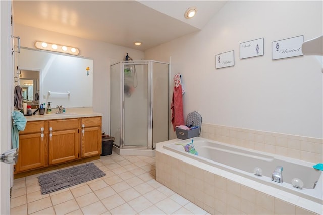 bathroom with tile patterned floors, a shower stall, a garden tub, and vanity