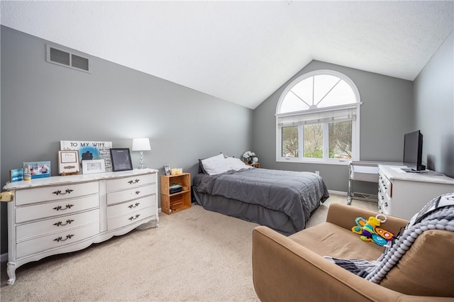 bedroom with visible vents, light carpet, and lofted ceiling