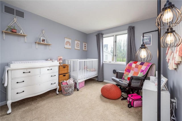 carpeted bedroom featuring visible vents and a crib