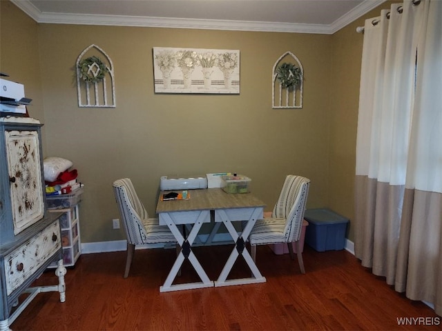 dining space with crown molding, baseboards, and wood finished floors