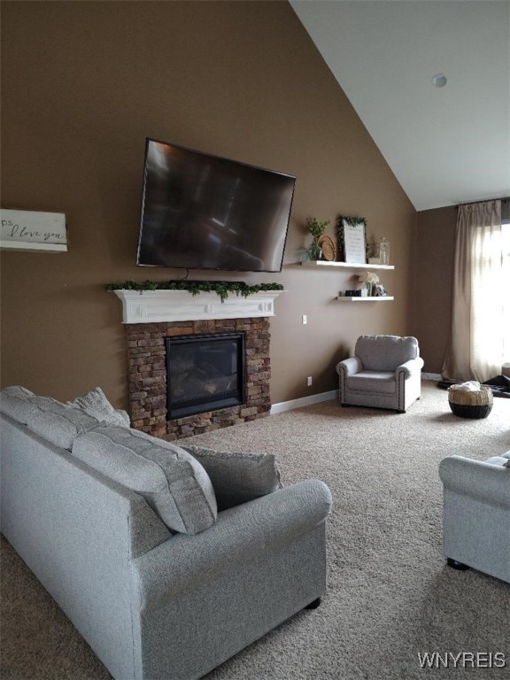 living area featuring a stone fireplace, carpet flooring, baseboards, and vaulted ceiling