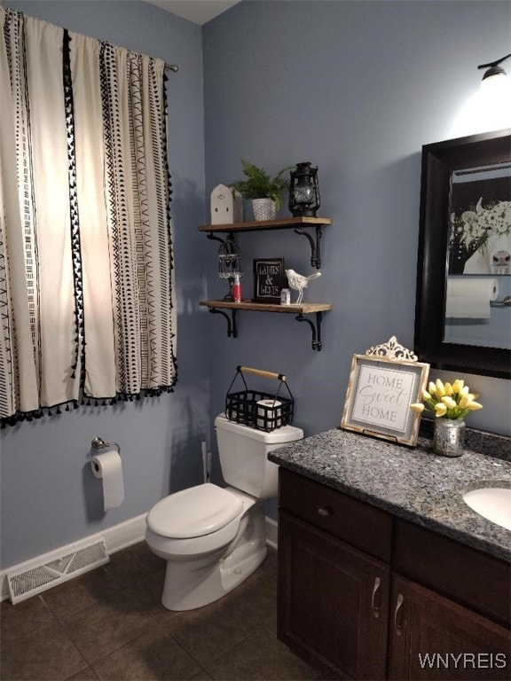 bathroom featuring visible vents, tile patterned flooring, baseboards, vanity, and toilet