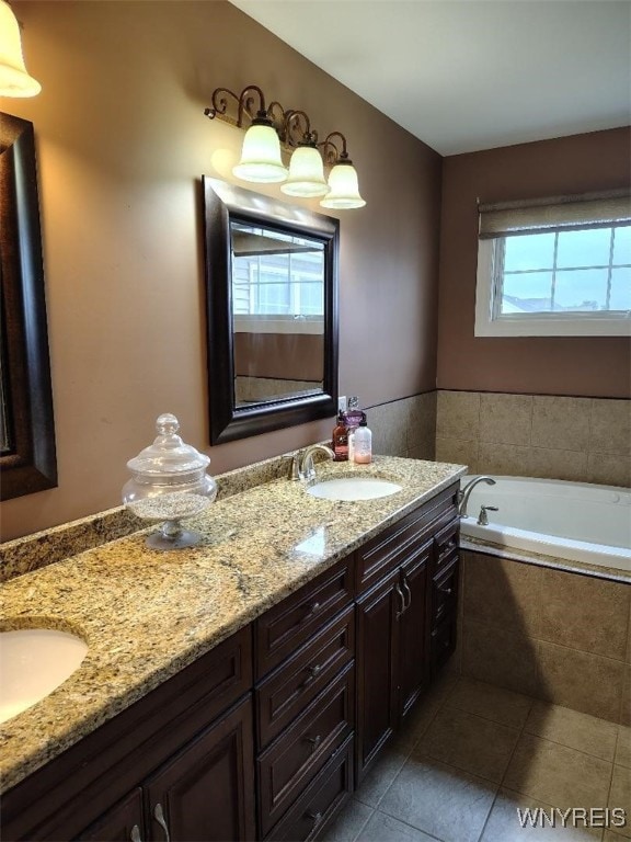 full bathroom with tile patterned flooring, a sink, a garden tub, and double vanity