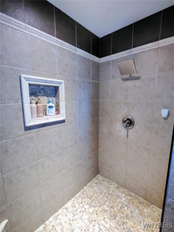 bathroom with tiled shower