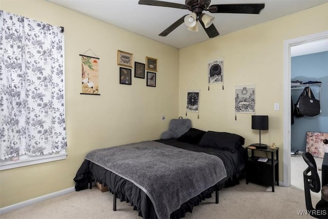 bedroom with baseboards, a ceiling fan, and light carpet