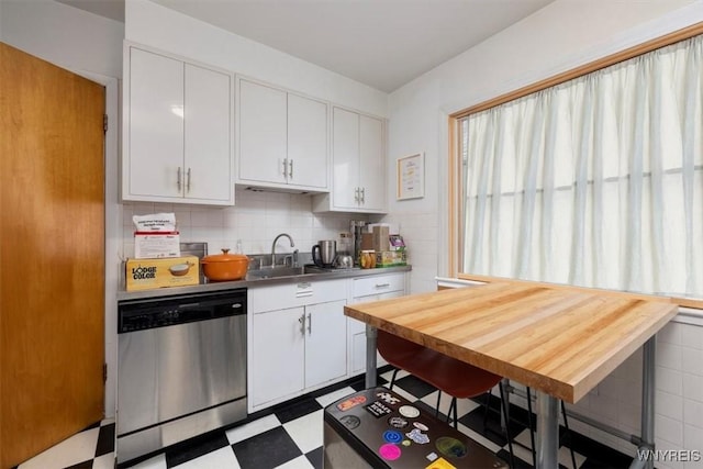 kitchen featuring a sink, tile patterned floors, white cabinets, and dishwasher