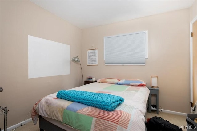 bedroom with carpet flooring and baseboards