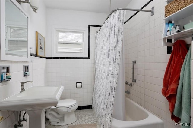 full bathroom with tile walls, tile patterned floors, shower / bath combo, and toilet