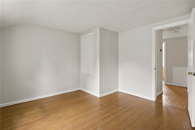 unfurnished room featuring baseboards and wood finished floors