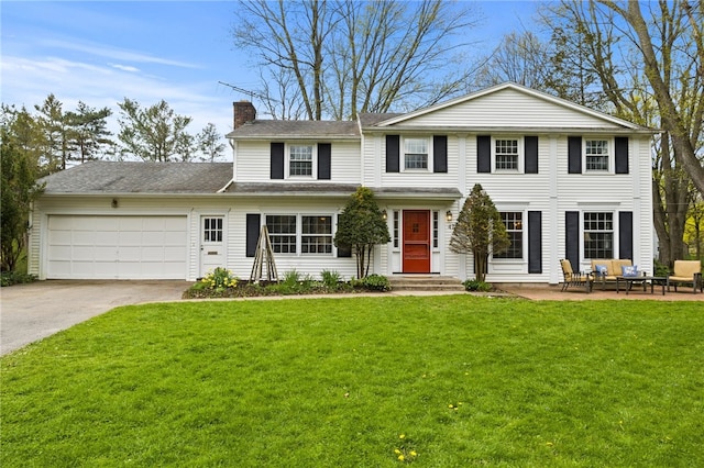 view of front of property with outdoor lounge area, a front yard, a chimney, concrete driveway, and an attached garage