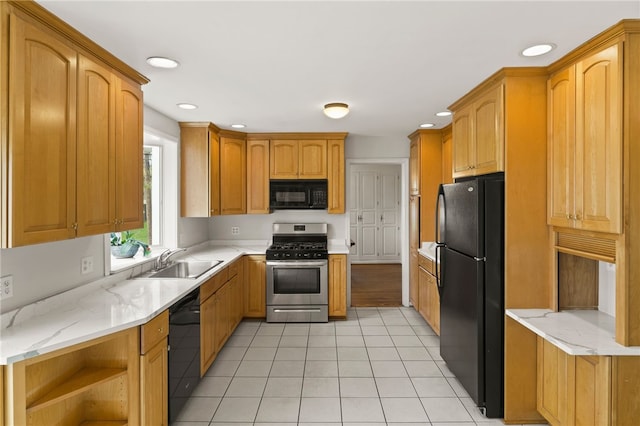 kitchen with recessed lighting, light stone counters, a sink, light tile patterned floors, and black appliances