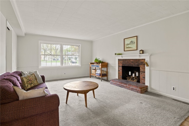 carpeted living room featuring crown molding, a brick fireplace, and visible vents