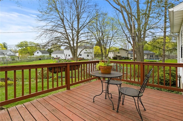 deck with a residential view, fence, and a lawn