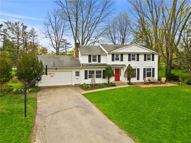 view of front of property with a garage, a front lawn, aphalt driveway, and a chimney