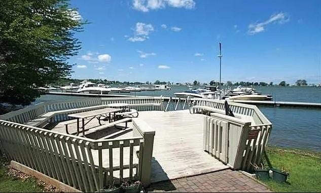 wooden terrace featuring a water view