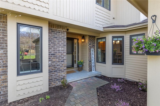 entrance to property featuring brick siding