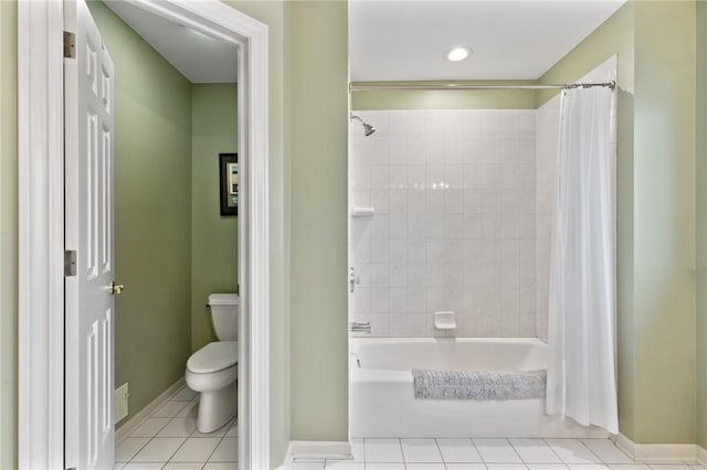 bathroom featuring baseboards, tile patterned flooring, toilet, and shower / tub combo with curtain