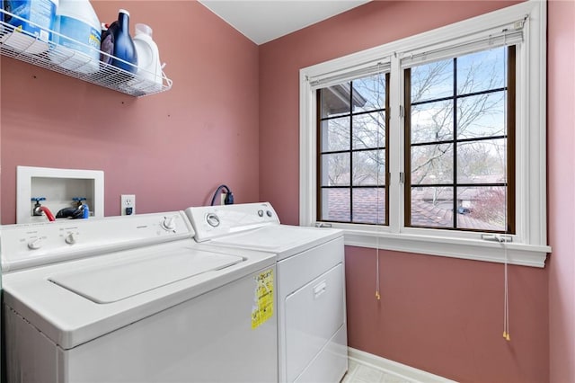 laundry area featuring separate washer and dryer, baseboards, and laundry area