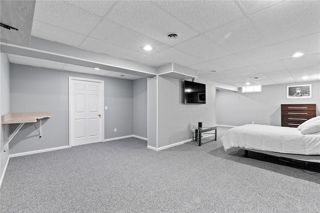 bedroom with baseboards, carpet flooring, and a drop ceiling
