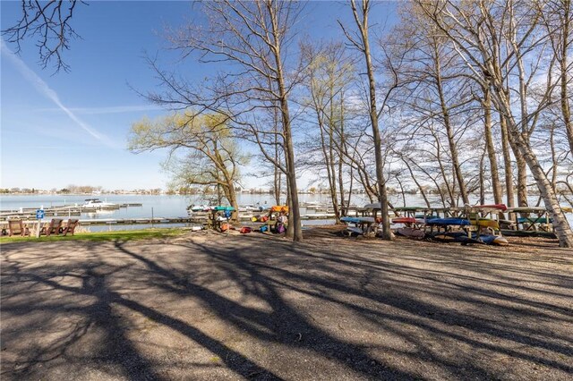 view of yard featuring a boat dock and a water view