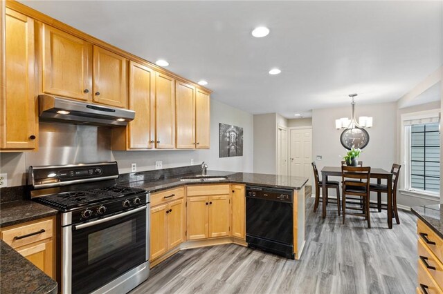 kitchen with under cabinet range hood, stainless steel range with gas stovetop, a sink, light wood finished floors, and dishwasher
