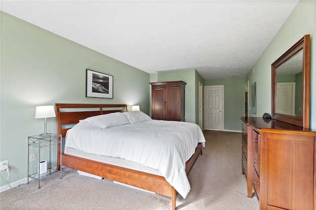 bedroom featuring baseboards and light carpet