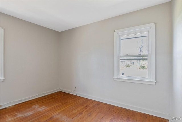 unfurnished room featuring baseboards and light wood-style flooring