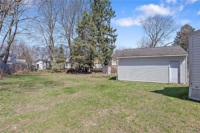 view of yard featuring fence and an outdoor structure