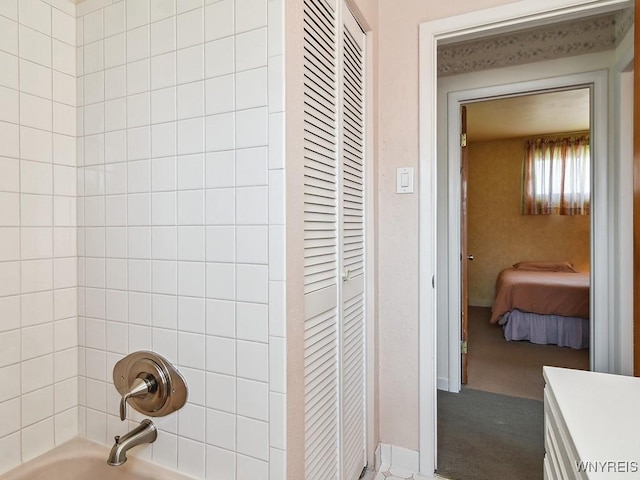 bathroom with vanity, bathing tub / shower combination, and a closet