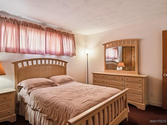 bedroom featuring dark colored carpet