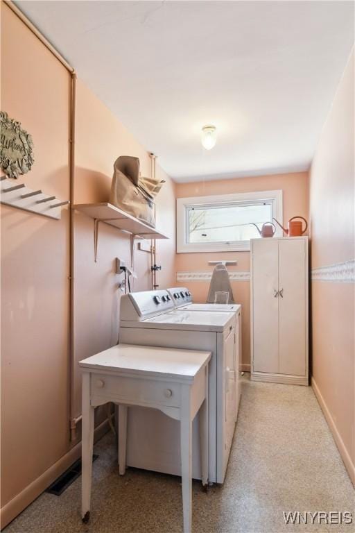 washroom featuring laundry area and washer and clothes dryer