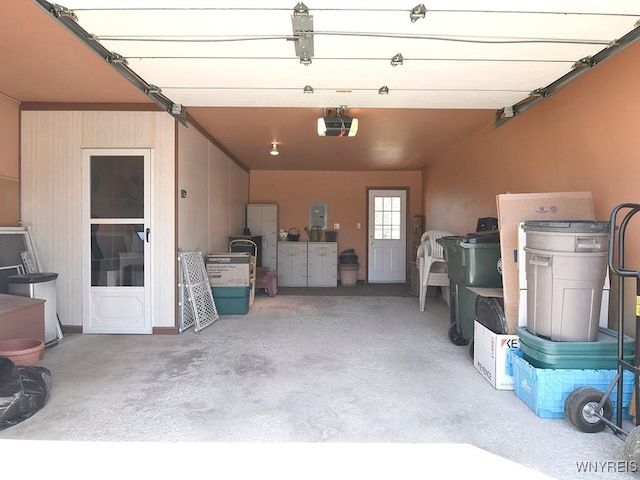 garage featuring a garage door opener and electric panel