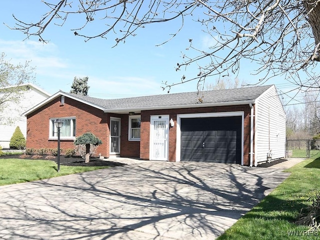 single story home with a front lawn, fence, brick siding, an attached garage, and driveway