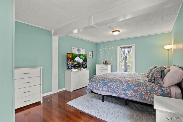 bedroom featuring a textured ceiling, baseboards, ornamental molding, and wood finished floors