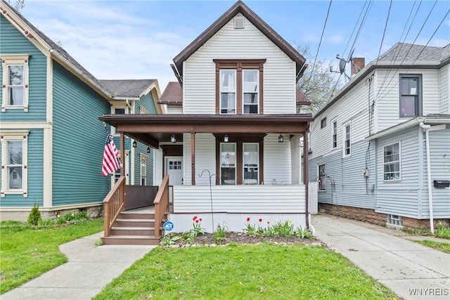 traditional-style house featuring covered porch and a front yard