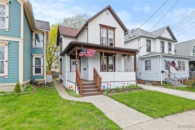 view of front of home with a porch and a front lawn